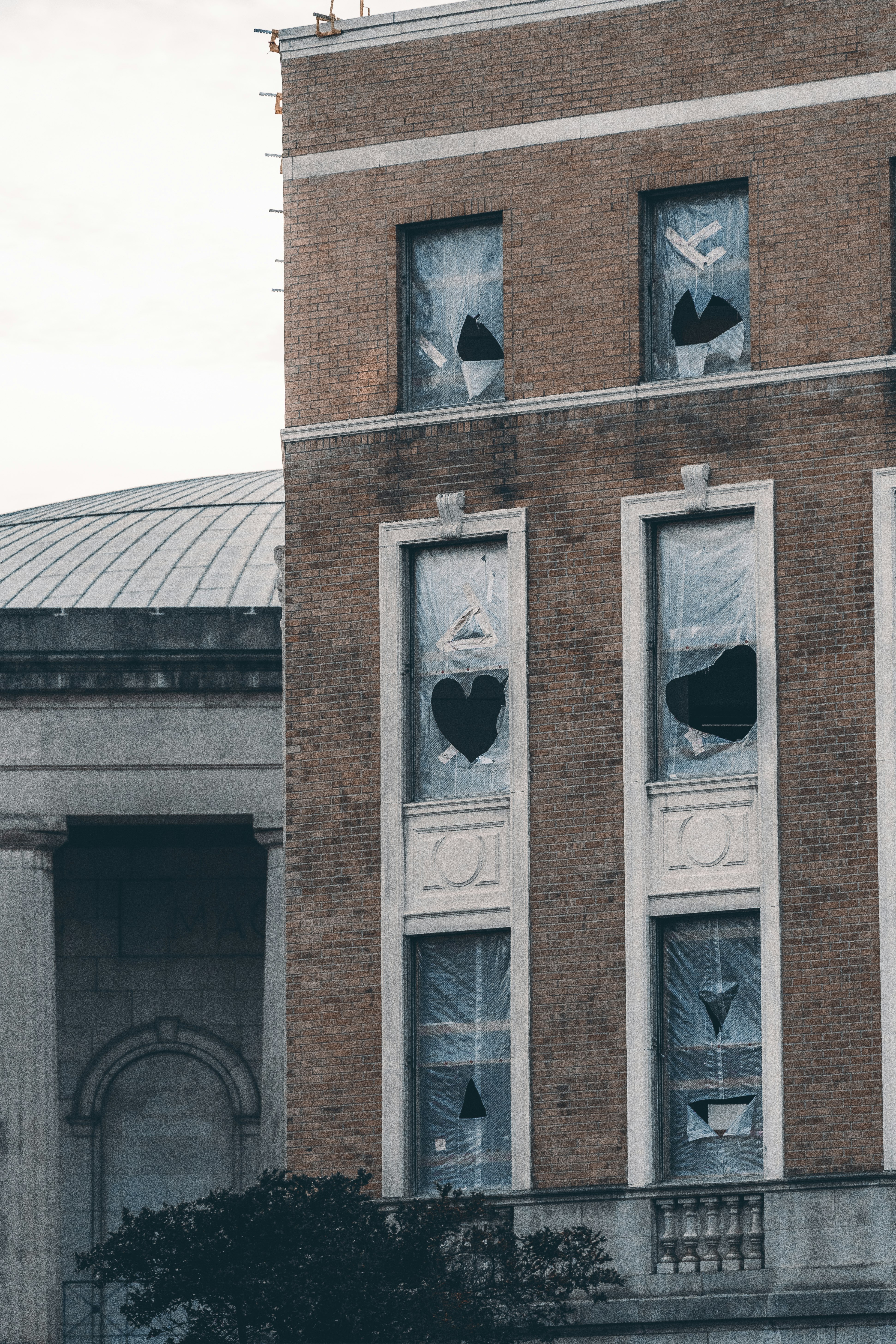 brown brick building with white wooden windows